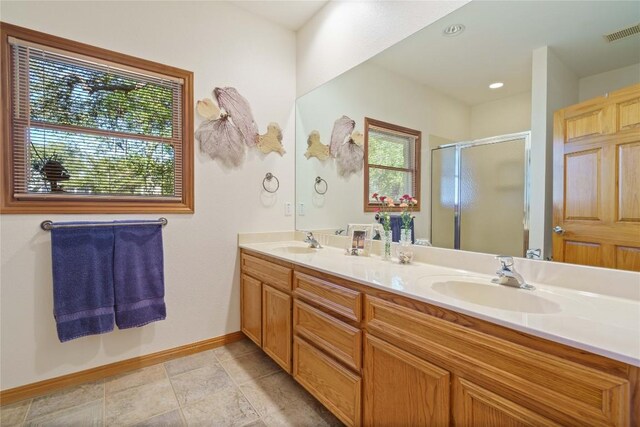 bathroom with walk in shower and vanity