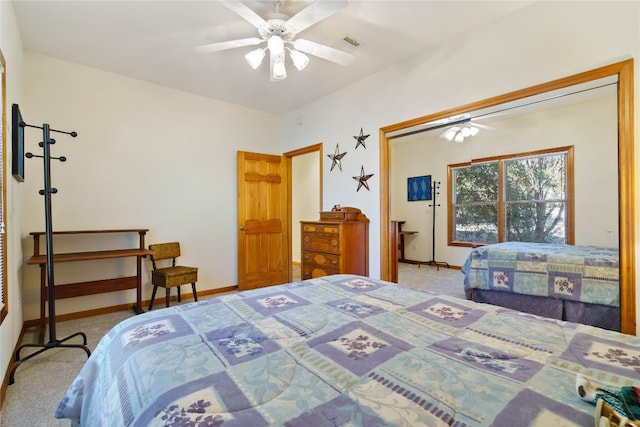 carpeted bedroom featuring ceiling fan and a closet