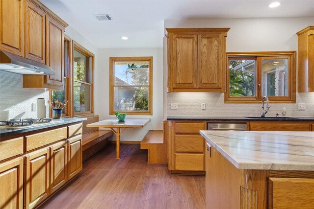 kitchen featuring tasteful backsplash, sink, appliances with stainless steel finishes, dark wood-type flooring, and butcher block counters