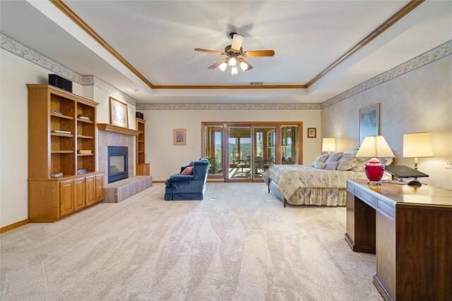 bedroom featuring ceiling fan, light colored carpet, and a raised ceiling