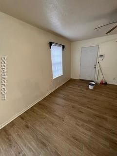 spare room featuring ceiling fan and dark hardwood / wood-style flooring