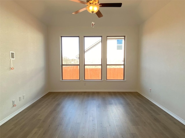 unfurnished room featuring dark wood-type flooring and ceiling fan