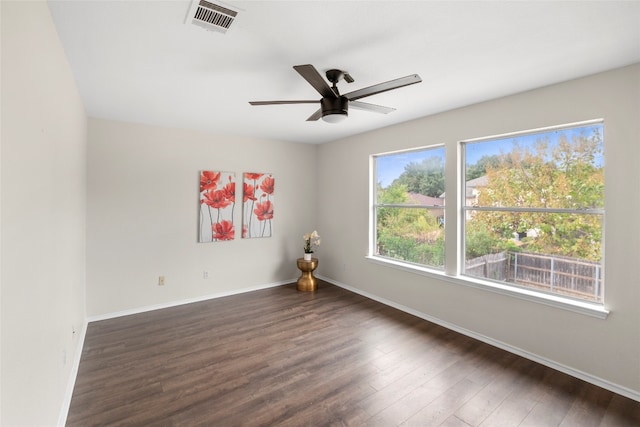 unfurnished room with dark wood-type flooring and ceiling fan