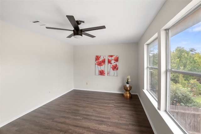 empty room with dark wood-type flooring and ceiling fan