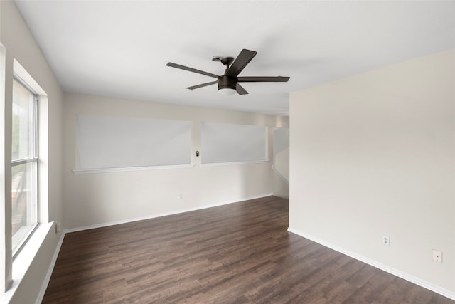 empty room featuring ceiling fan and dark hardwood / wood-style flooring