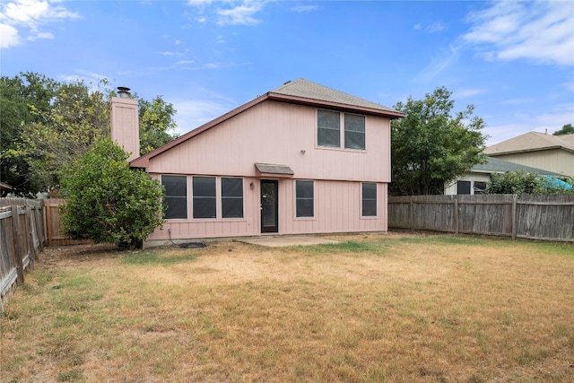 back of house with a yard