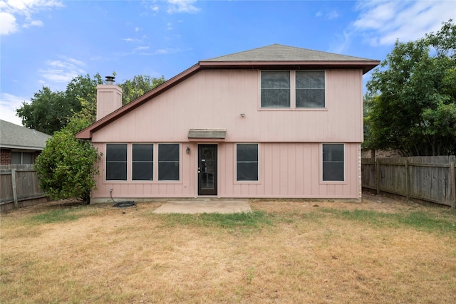 rear view of house featuring a patio and a lawn