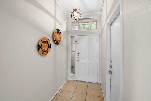 entryway with crown molding and light tile patterned floors