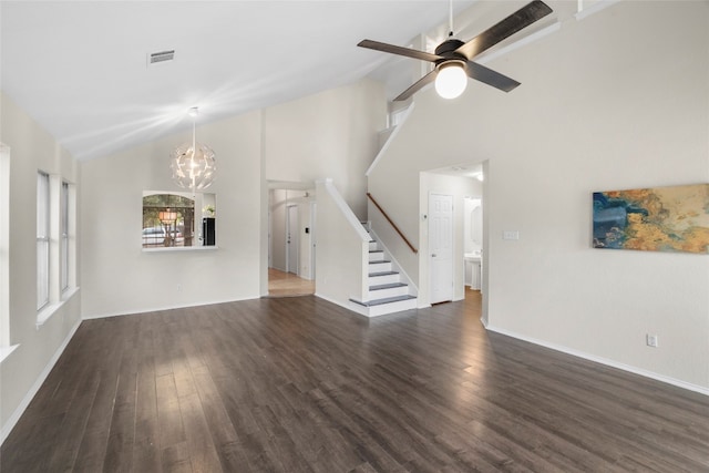 unfurnished living room featuring high vaulted ceiling, ceiling fan with notable chandelier, and dark hardwood / wood-style flooring