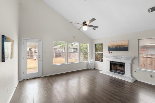 unfurnished living room with dark hardwood / wood-style floors, ceiling fan, high vaulted ceiling, and a wealth of natural light