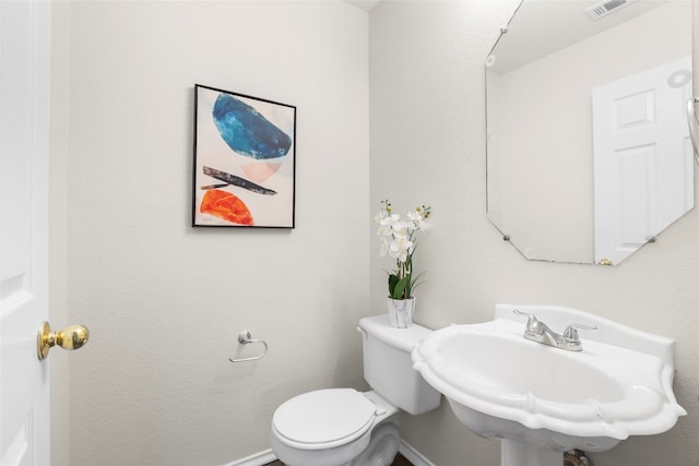 bathroom featuring toilet and sink