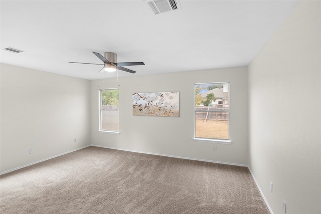 empty room featuring carpet floors and ceiling fan