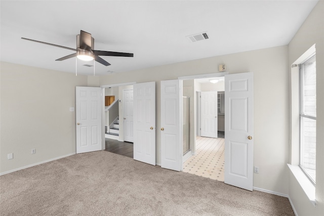 unfurnished bedroom featuring ceiling fan and carpet floors