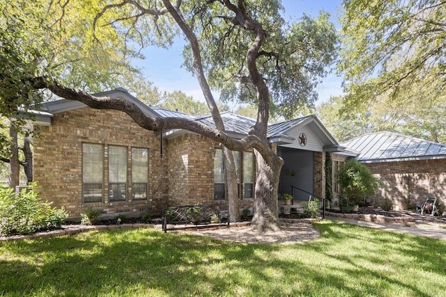 300 Delaware Springs Blvd, Burnet, TX 78611 - single story home featuring brick siding, a front lawn, and a standing seam roof