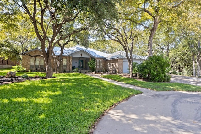 ranch-style home with a front yard and a garage