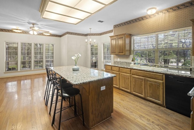 300 Delaware Springs Blvd, Burnet, TX 78611 - kitchen with dishwasher, a kitchen bar, a chandelier, ceiling fan, and a kitchen island