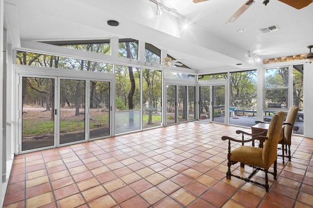 unfurnished sunroom with rail lighting, ceiling fan, and vaulted ceiling