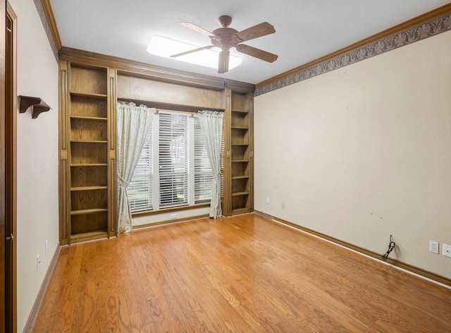 unfurnished room featuring light hardwood / wood-style floors, ornamental molding, and ceiling fan