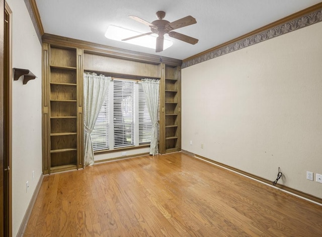 300 Delaware Springs Blvd, Burnet, TX 78611 - unfurnished room featuring ornamental molding, a ceiling fan, wood finished floors, and built in features