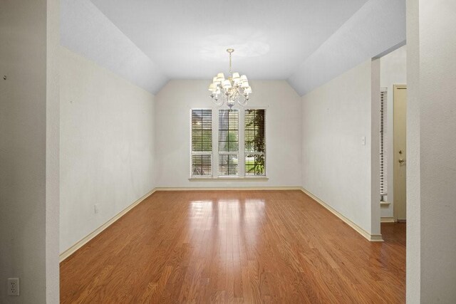 300 Delaware Springs Blvd, Burnet, TX 78611 - spare room with wood finished floors, a chandelier, and lofted ceiling