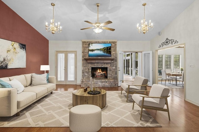 300 Delaware Springs Blvd, Burnet, TX 78611 - living area featuring a chandelier, light wood-style floors, a fireplace, plenty of natural light, and high vaulted ceiling