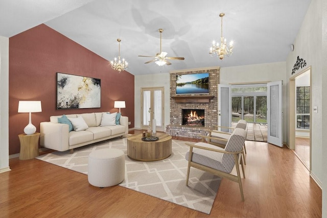 300 Delaware Springs Blvd, Burnet, TX 78611 - living area with ceiling fan, wood finished floors, a fireplace, a chandelier, and high vaulted ceiling