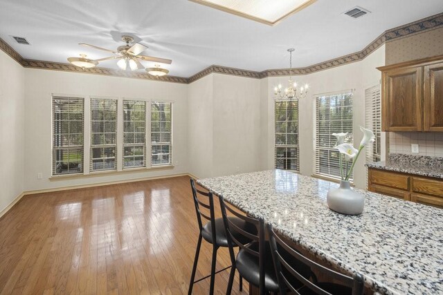 300 Delaware Springs Blvd, Burnet, TX 78611 - kitchen with plenty of natural light, light stone counters, and a chandelier
