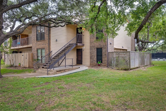 back of house with a lawn