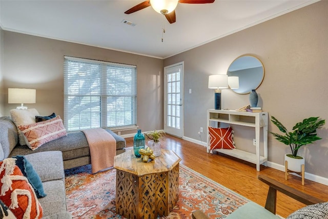4159 Steck Ave Unit 290, Austin, TX 78759 - living area with wood finished floors, ceiling fan, baseboards, and ornamental molding