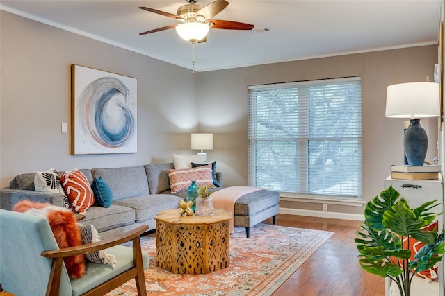 living room featuring ornamental molding, a healthy amount of sunlight, hardwood / wood-style flooring, and ceiling fan