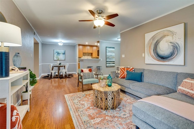 4159 Steck Ave Unit 290, Austin, TX 78759 - living room featuring light wood-style floors, a ceiling fan, crown molding, and baseboards