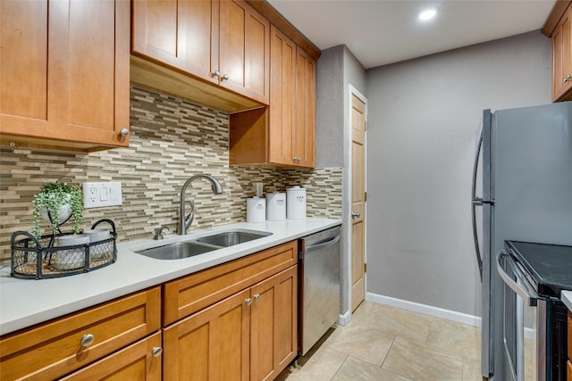 kitchen featuring sink, appliances with stainless steel finishes, and tasteful backsplash