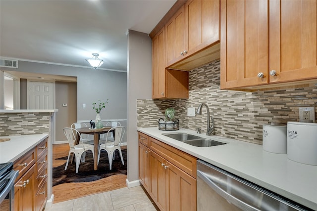 kitchen featuring sink, light tile patterned flooring, stainless steel appliances, crown molding, and decorative backsplash