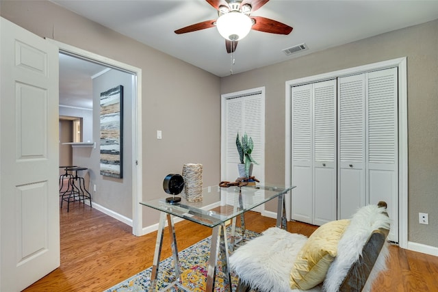 office featuring light wood-type flooring and ceiling fan