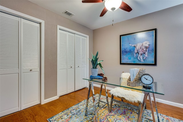 office area with wood-type flooring and ceiling fan