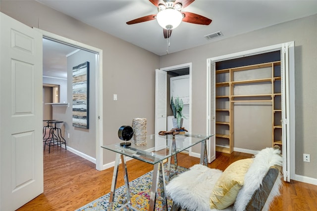 office with wood-type flooring and ceiling fan