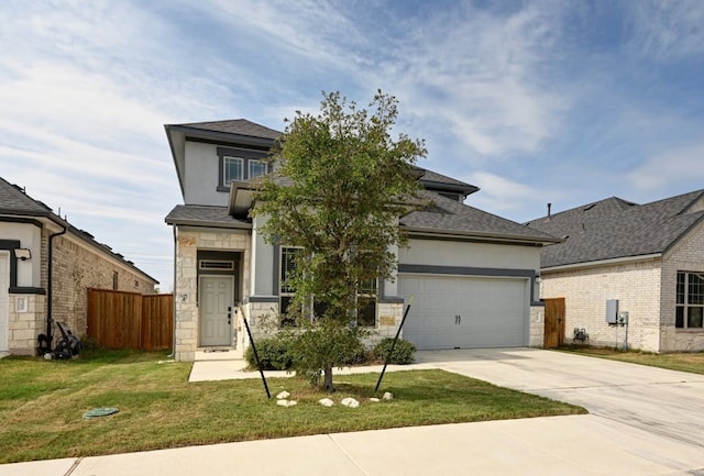 view of front of property with a front lawn and a garage