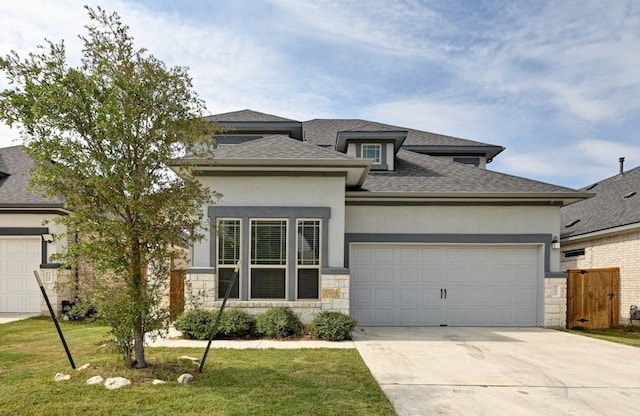 prairie-style home featuring a front yard and a garage