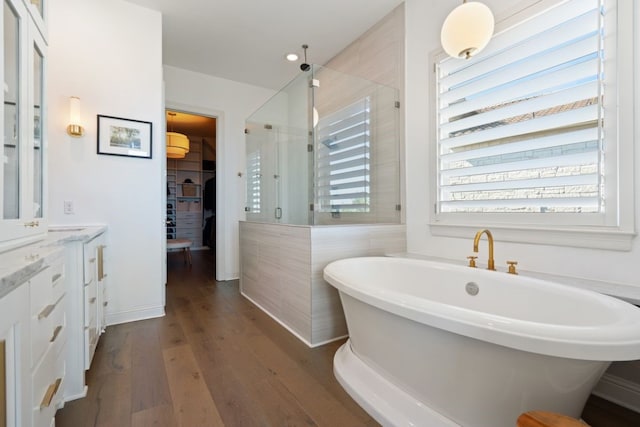 bathroom featuring vanity, tile walls, shower with separate bathtub, and hardwood / wood-style floors