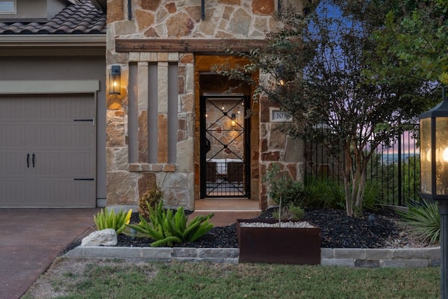 exterior entry at dusk with a garage