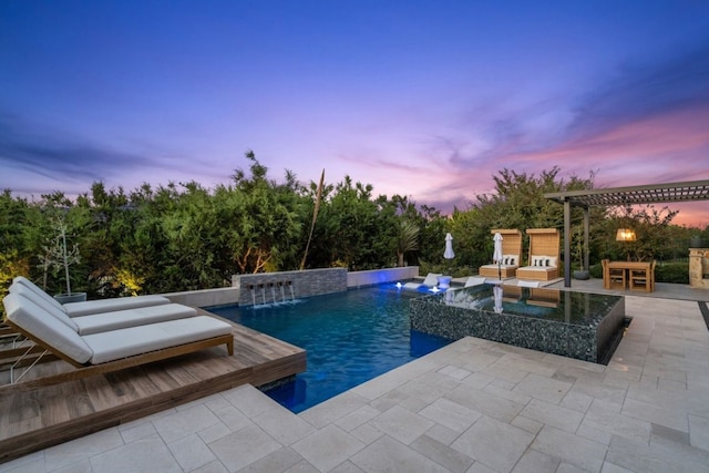 pool at dusk with a pergola, a patio, and pool water feature