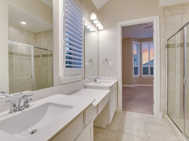 bathroom featuring vanity, a shower with shower door, and tile patterned floors