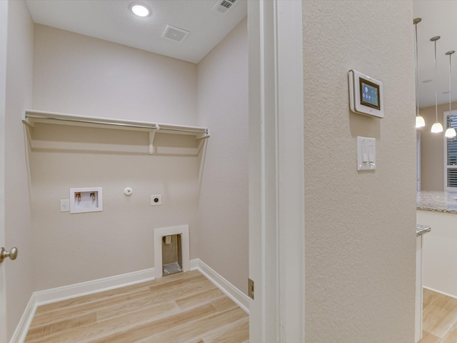 laundry area with hookup for an electric dryer, washer hookup, gas dryer hookup, and hardwood / wood-style floors