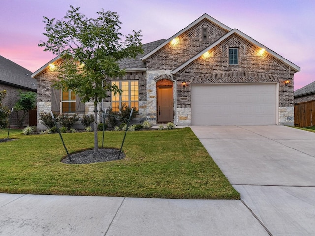 view of front facade with a lawn and a garage