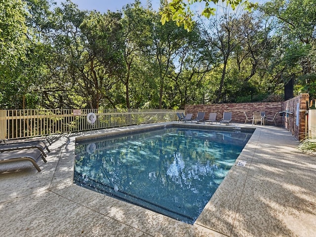 view of swimming pool featuring a patio area