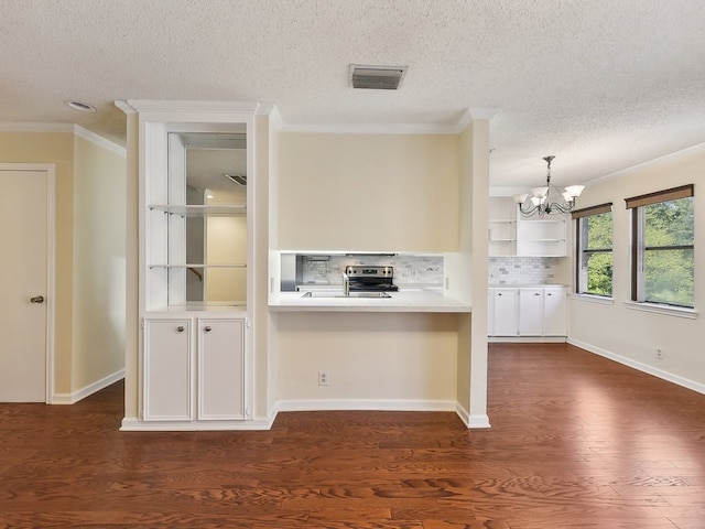 kitchen with dark wood-type flooring, tasteful backsplash, decorative light fixtures, and a chandelier