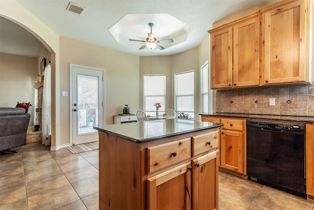 kitchen with tasteful backsplash, dishwasher, a kitchen island, ceiling fan, and light tile patterned floors