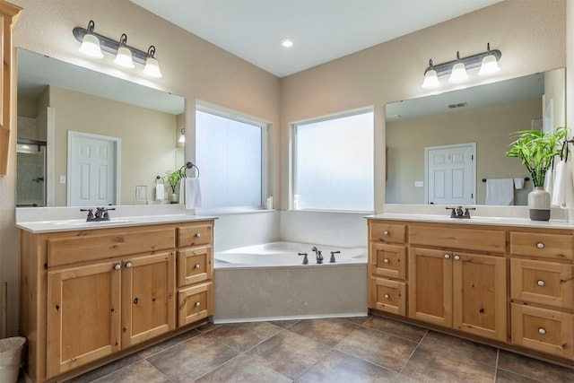 bathroom featuring vanity and shower with separate bathtub