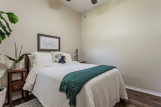 bedroom featuring dark wood-type flooring, ceiling fan, and vaulted ceiling