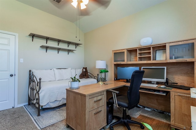 office area featuring ceiling fan, dark carpet, and vaulted ceiling